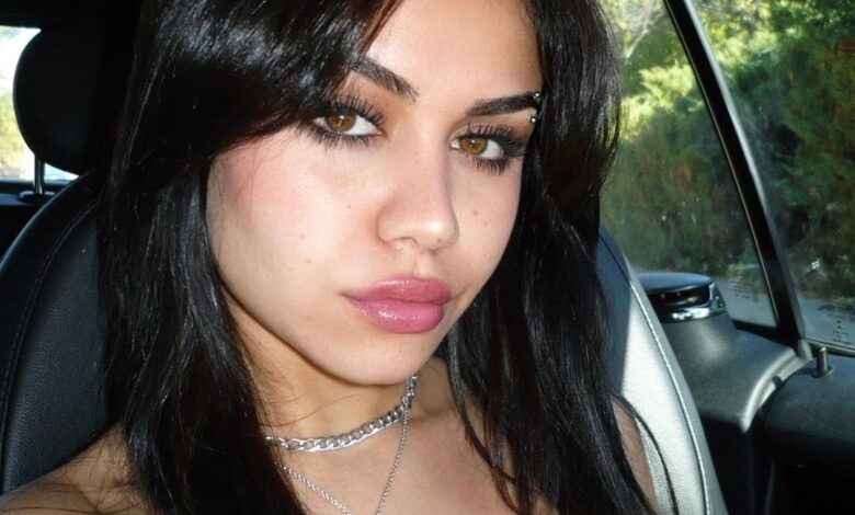 Tara Yummy smiling in a candid moment, showcasing her youthful style and personality at age 24